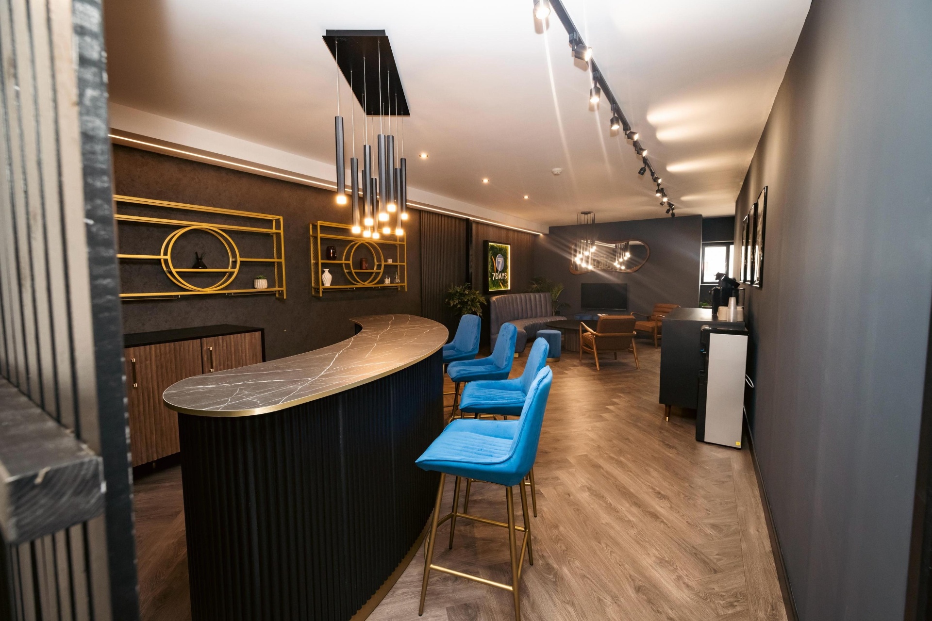 Contract furniture fit-out, bespoke bar counter, velvet stools and lounge seating in a hospitality venue by Red Kite Furniture