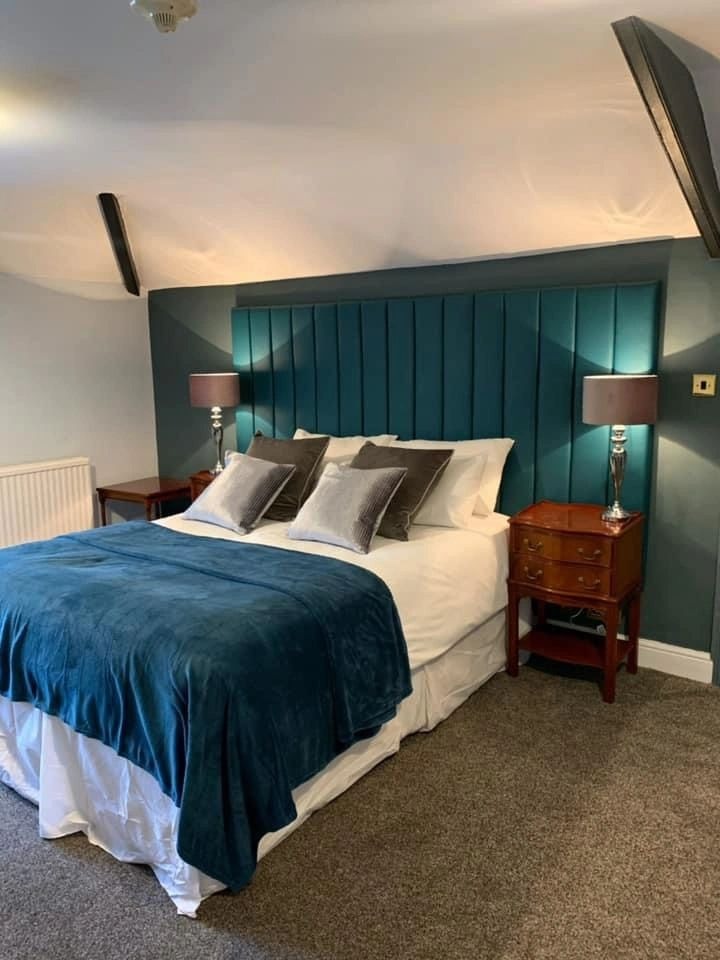 Bespoke teal channel-back upholstered headboard, made to a client's specification