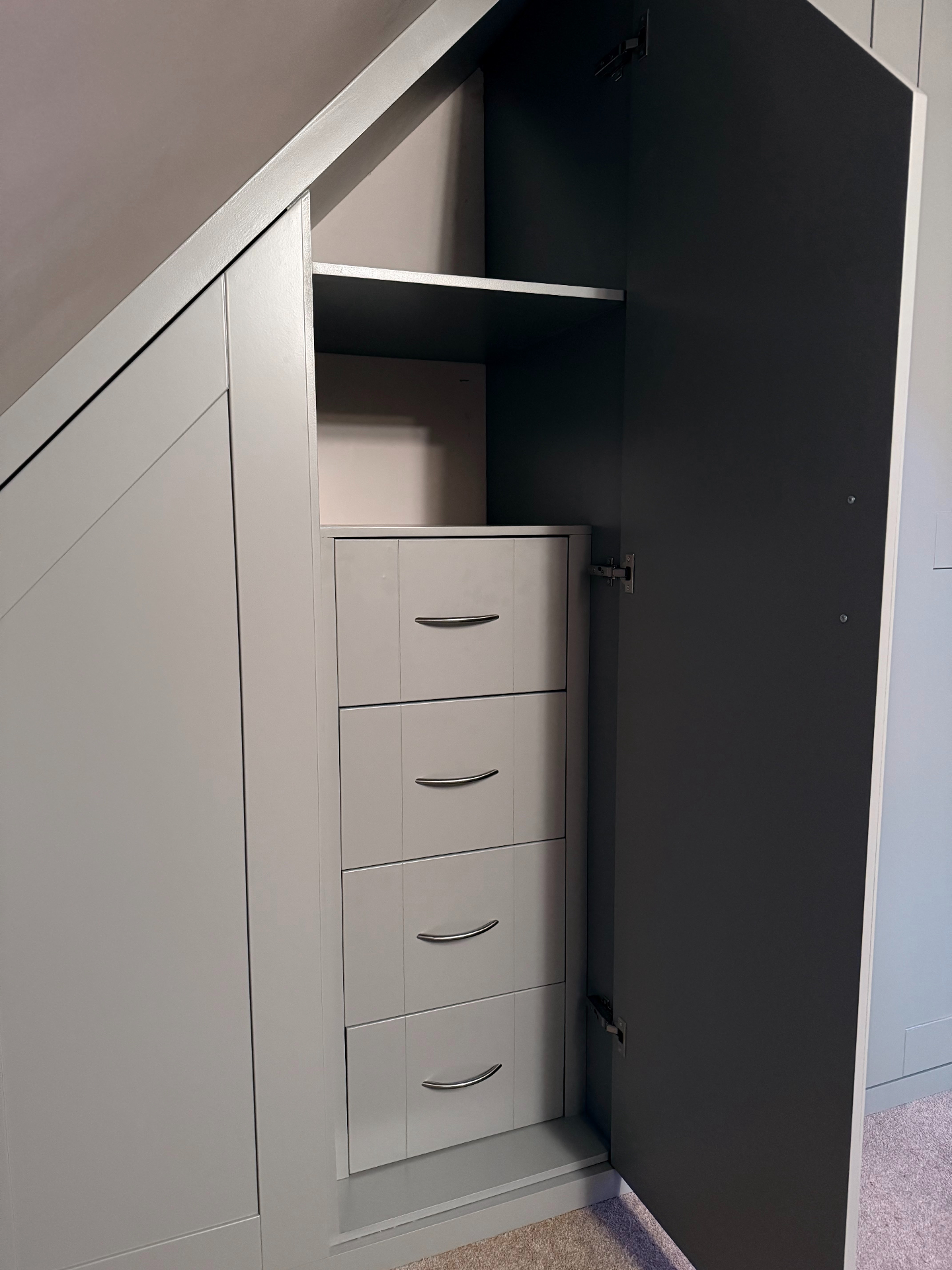 Bespoke eaves wardrobe with internal drawers pulled open