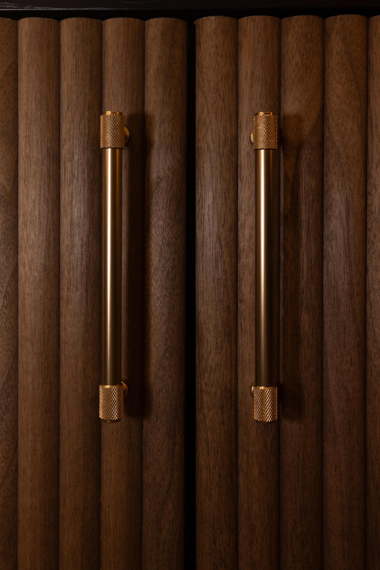 Bespoke fluted walnut cabinet with knurled brass handles, manufactured in the Red Kite Furniture Norwich workshop