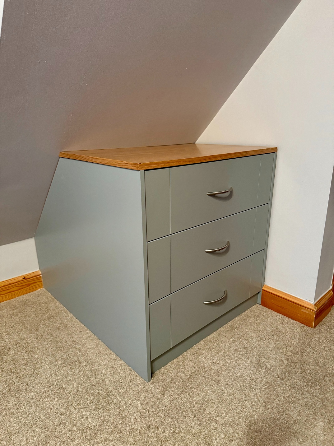 Angled view of a bespoke fitted chest of drawers with a matched painted finish